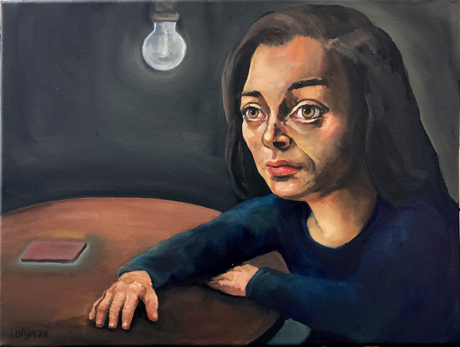 Woman lit with a single lightbulb and a glowing phone just out of reach