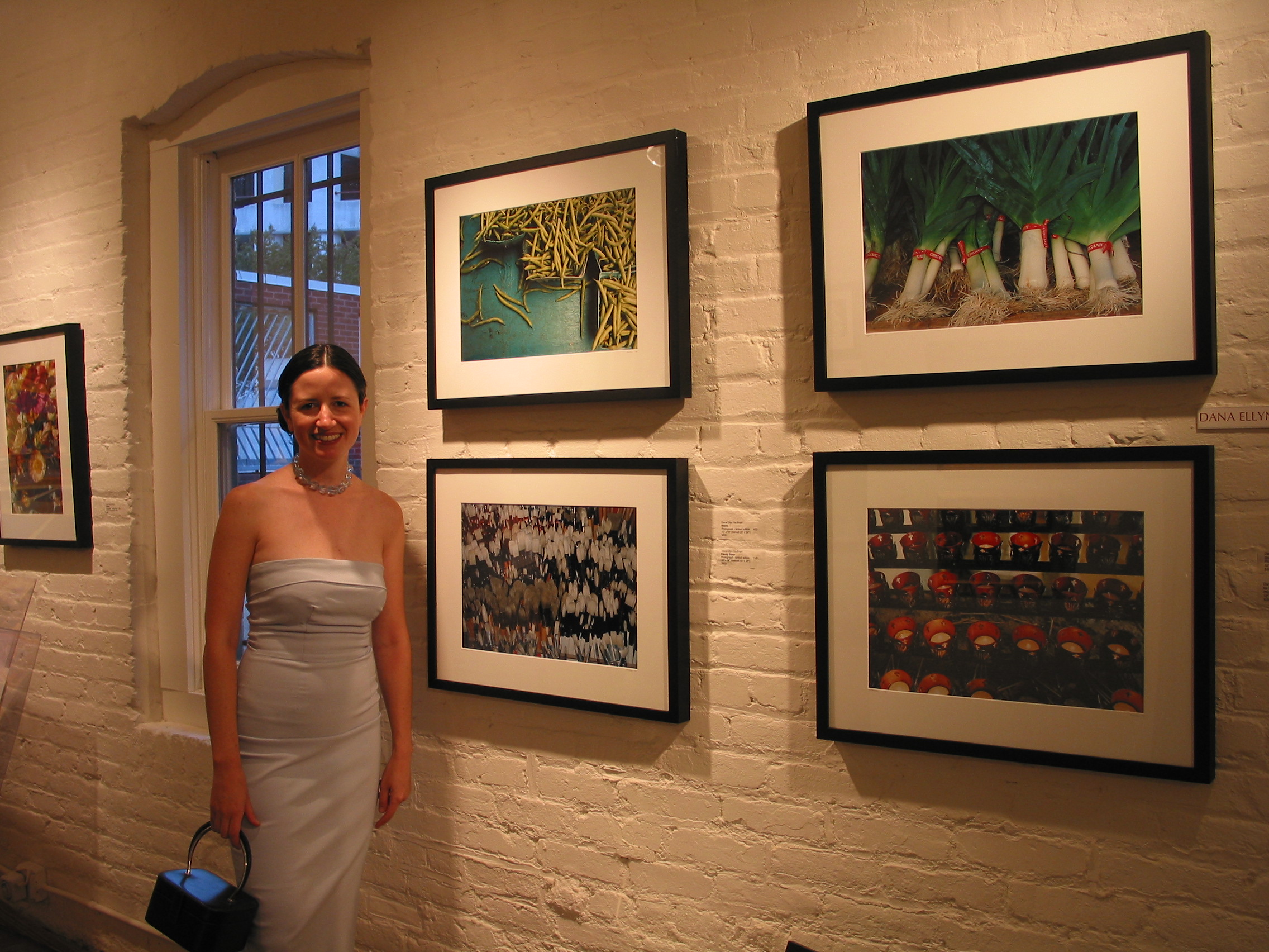 Dana Ellyn standing beside her four photographs on display at Gallery 325, 2002