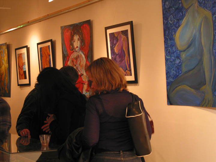 Gallery visitors viewing the Nudes paintings on the gallery wall at NZen Gallery, 2002