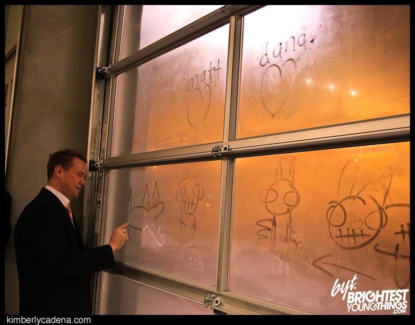 Matt drawing in the fog on the gallery window