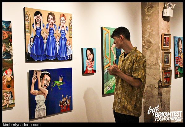 A guest beside paintings