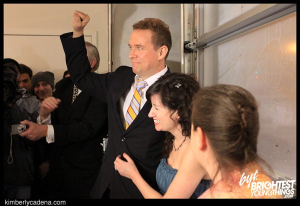 Matt Sesow raises a fist during the wedding ceremony