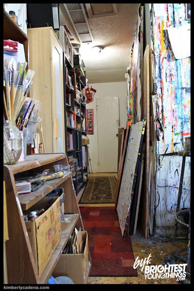 A hallway lined with paintings