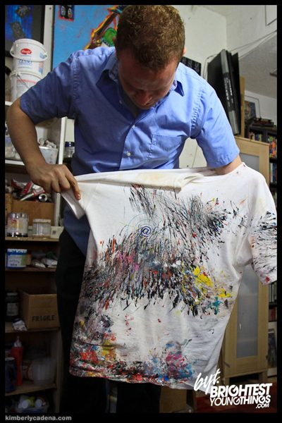 Matt holding up a paint-covered shirt