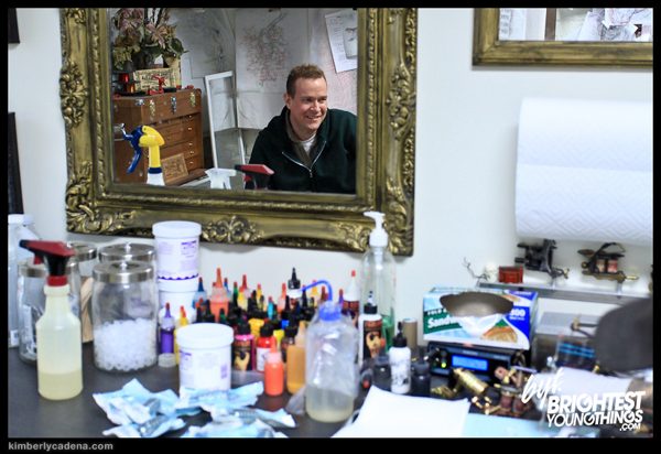Matt in a mirror at the tattoo shop