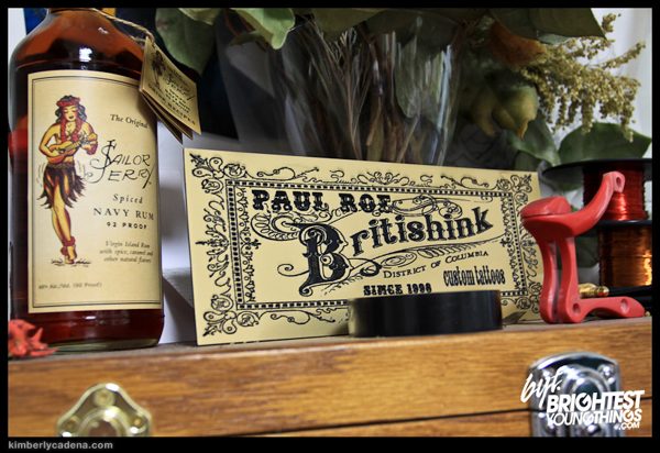 A bottle and a Britishink sign at the tattoo shop