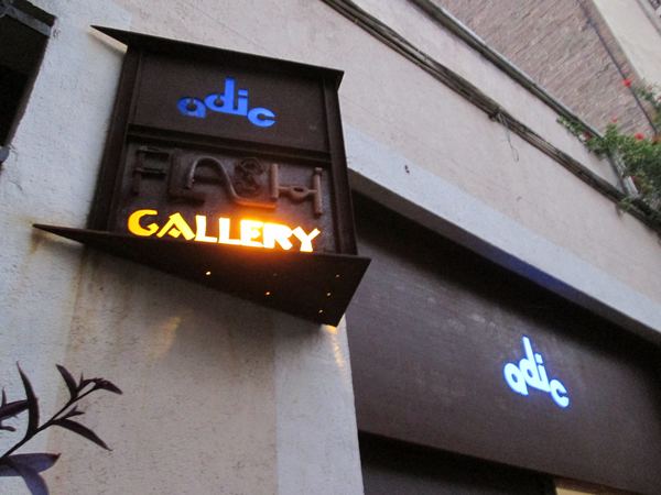 The lit Flash Gallery sign at dusk