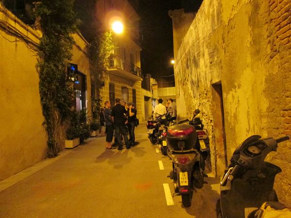 Visitors gathered in the narrow street outside Flash Gallery at night