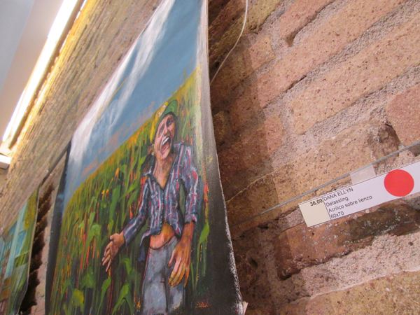 Dana Ellyn's painting Detassling with its label and a red sold dot