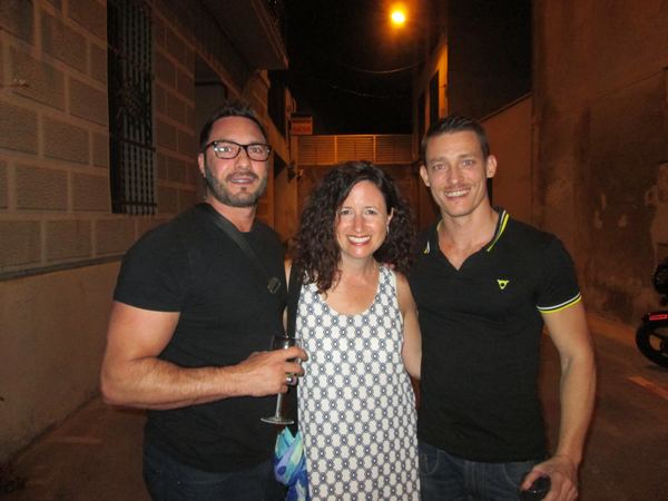 Dana Ellyn with two guests in the street outside the gallery at night