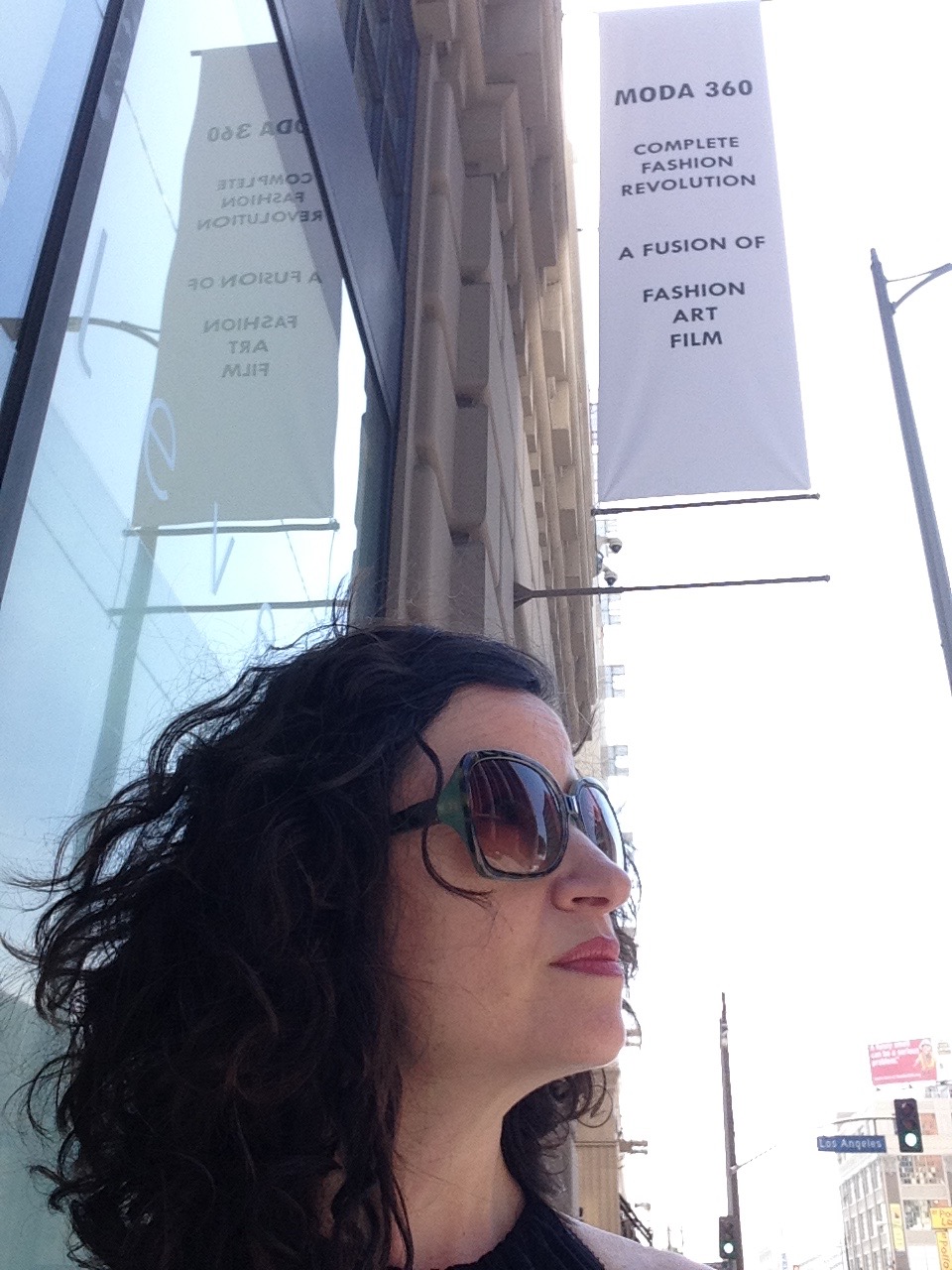 Dana Ellyn outside The New Mart under a Moda 360 banner reading Complete Fashion Revolution