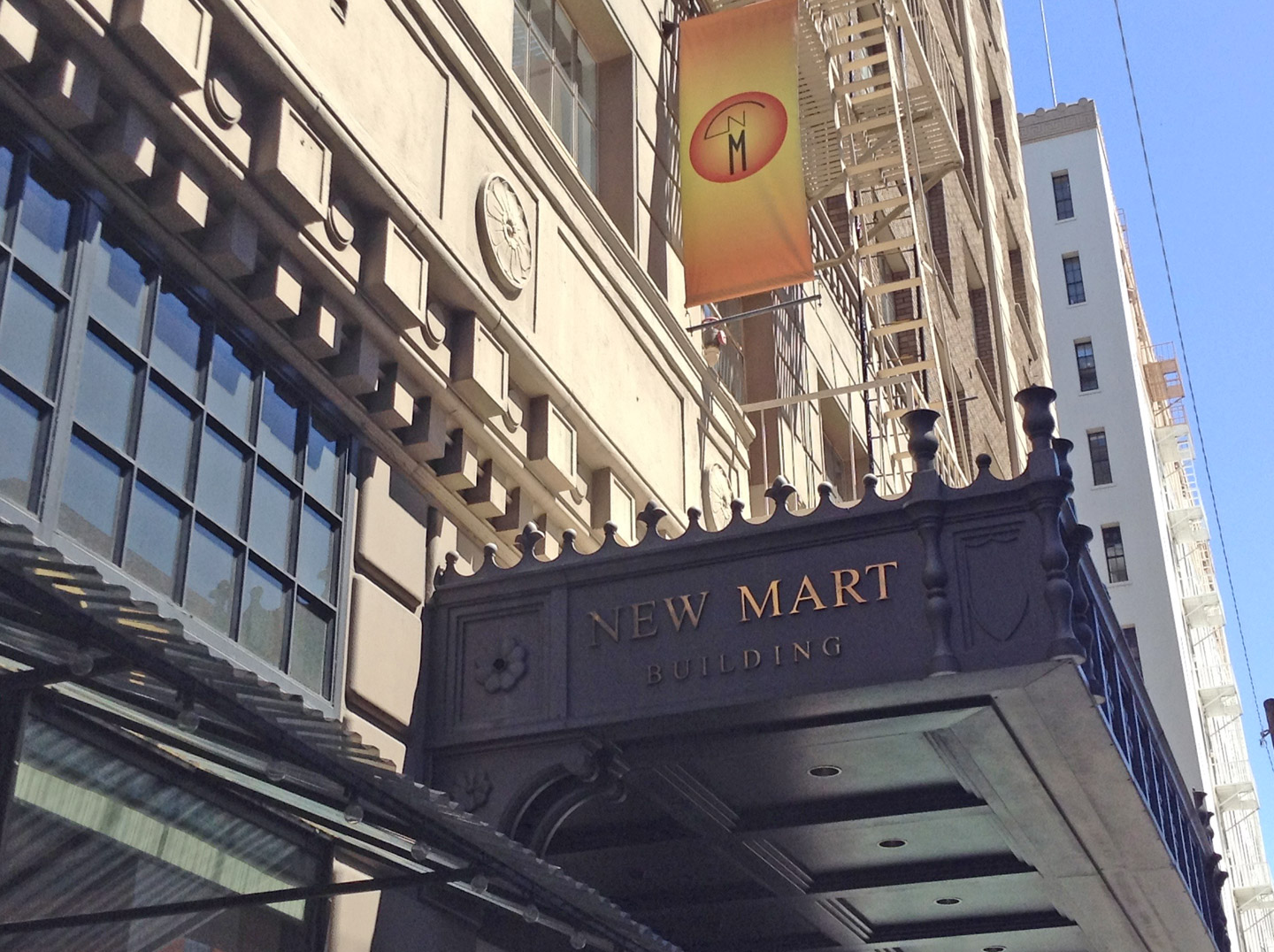 The New Mart Building marquee in downtown Los Angeles, with an orange New Mart banner above