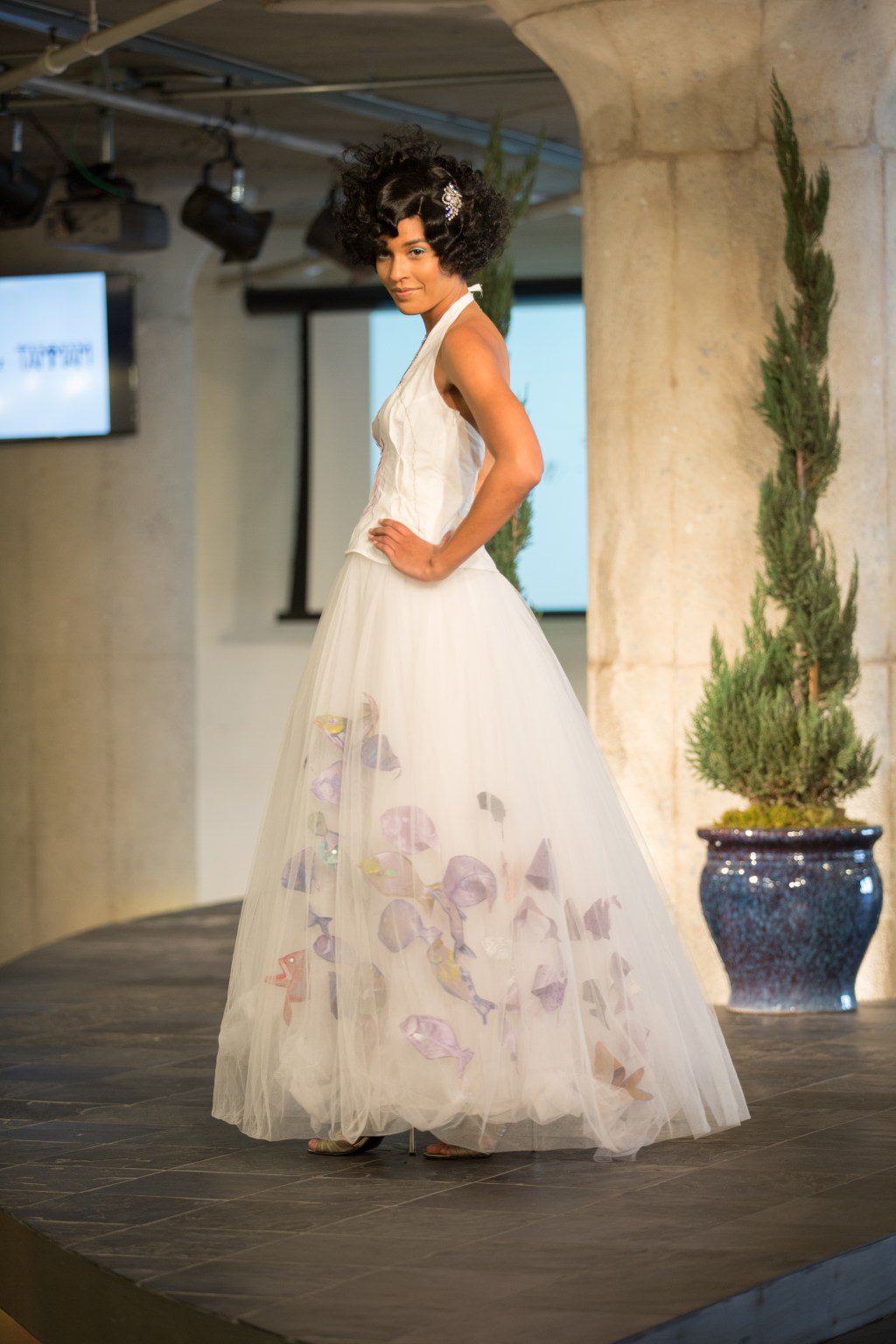 Model on the Moda 360 runway in the Bycatch, By Hand tulle gown with painted fish on the skirt