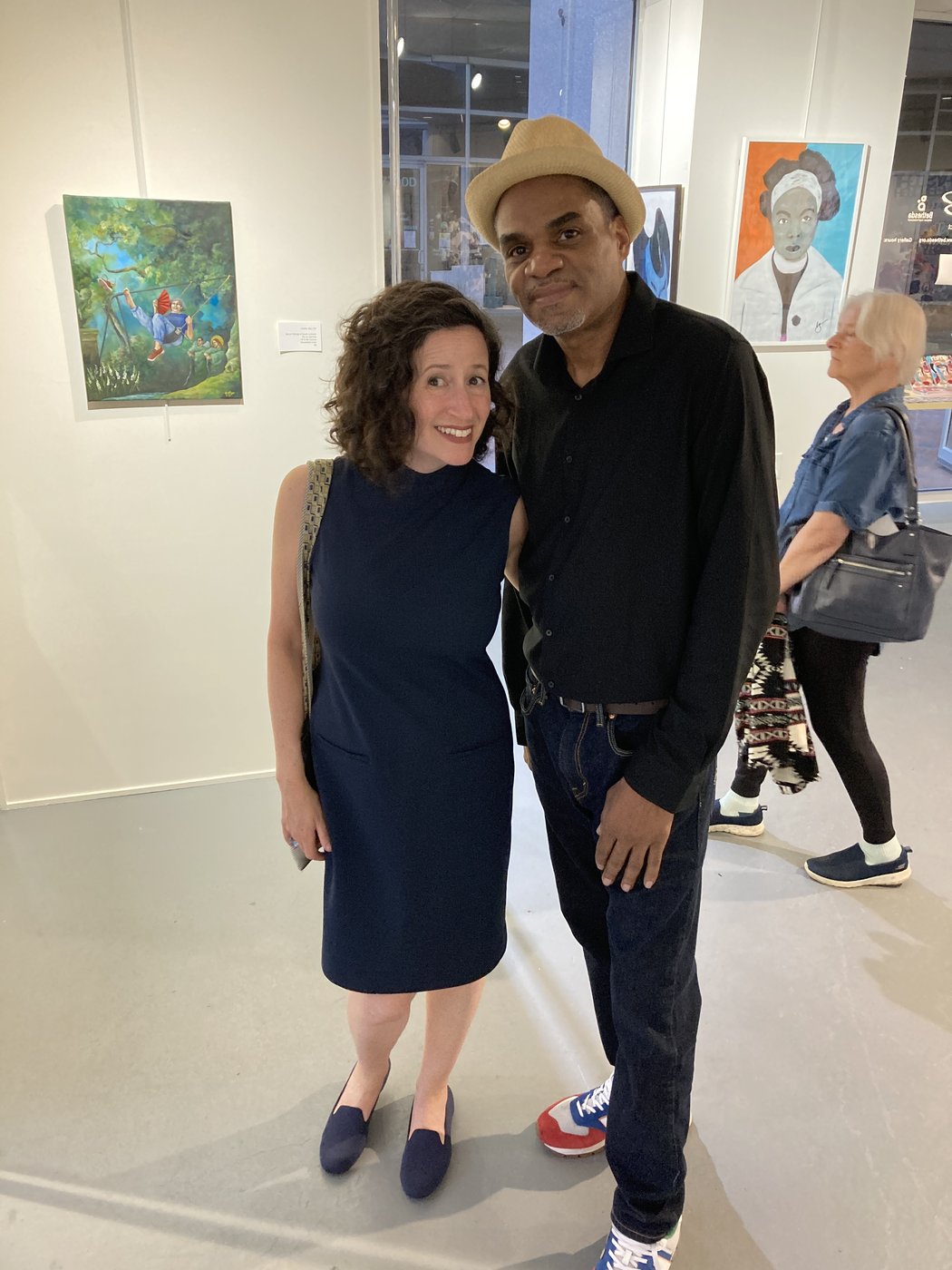 Dana Ellyn with Michael Hyman at the c'est l'art opening reception, her painting (Rococo) Mood Swing on the wall behind
