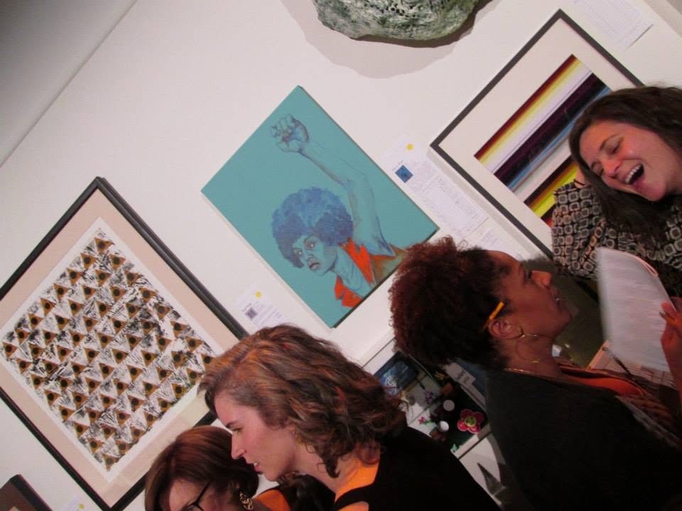 Guests crowded in front of Dana Ellyn's painting Angela at the 2014 Transformer auction