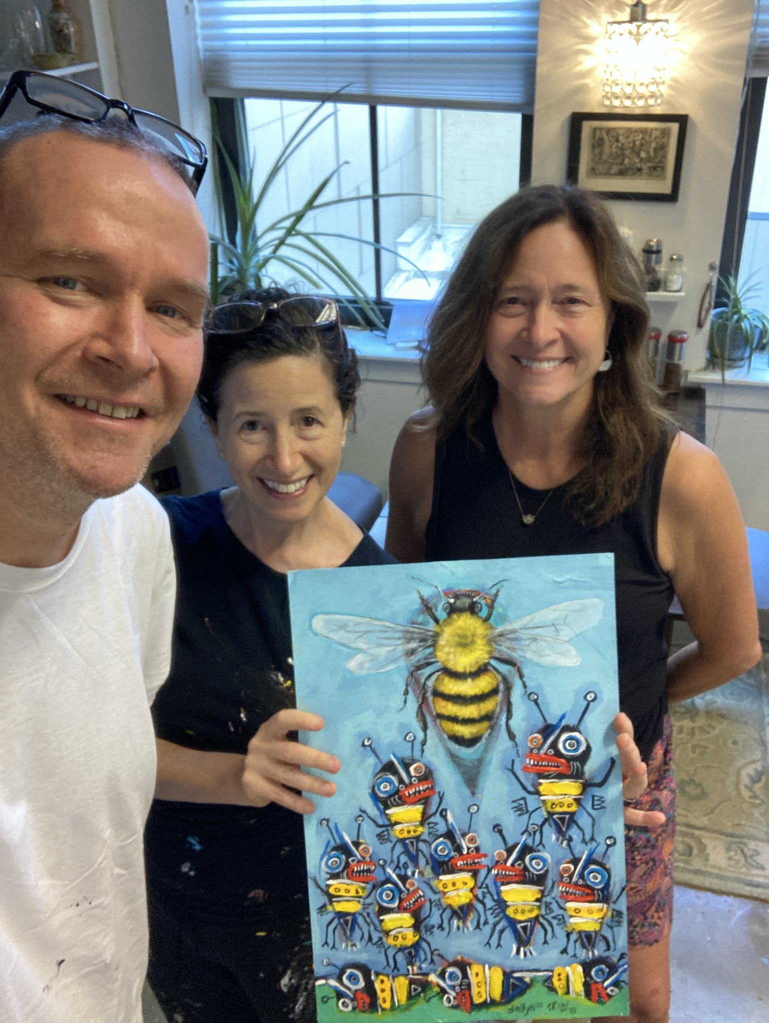 Collectors holding original paintings after visiting the Sesow and Ellyn studio at Mather Studios, Washington DC